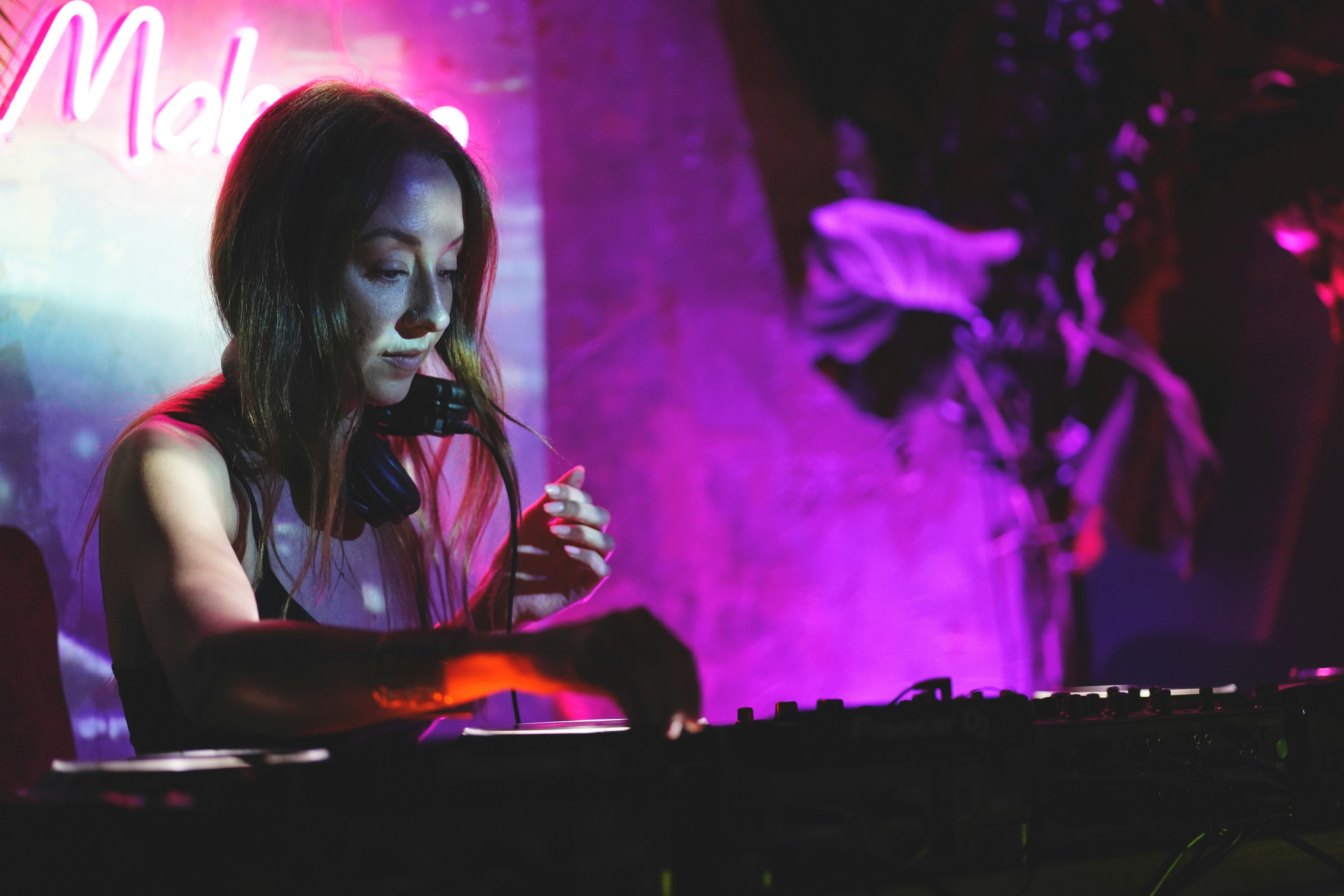 A DJ performing for a packed, energized crowd